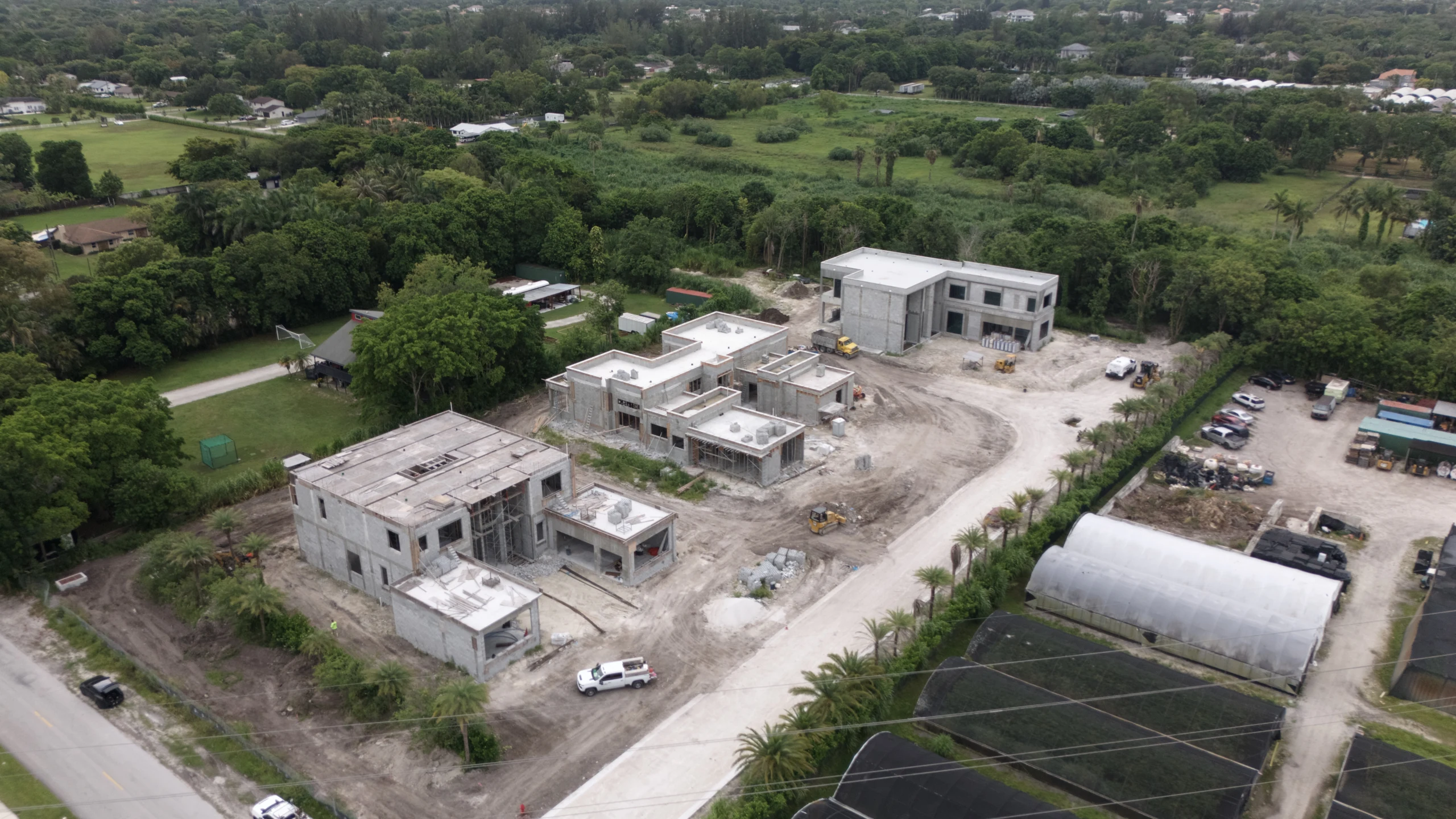 Aerial photograph of the three Villa Bello residences under construction in June 2026